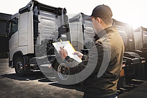 Truck Drivers Holding A Clipboard Checking Truck Wheels Tires. Maintenance Checklist. Freight Truck Transport.