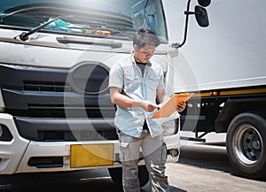 Truck Drivers Holding A Clipboard Checking The Trucks. Maintenance Checklist. Freight Truck Transport.