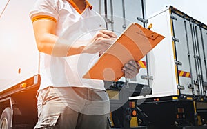 Truck Drivers Holding A Clipboard Checking The Trucks. Truck Inspection Safety Driving. Freight Truck Transport.