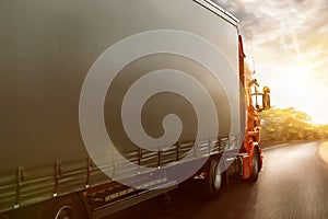 Truck drives on a country road at sunset