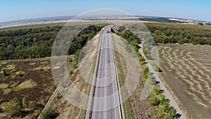 Truck driving along empty freeway in Russia. Aerial drone view.