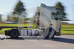 Truck driving down the street with motion blur background