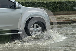 Truck driving through flood water on the road