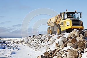 Truck driving on snowy rocky pier