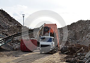 Truck dump unloading of broken concrete slabs demolition waste on landfill. Re-use concrete. Salvaging and recycling building and