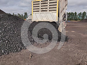 The truck dumping coal cargo at the stockpile