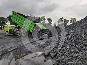 The truck dumping coal at stockpile