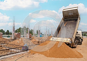 Truck dumping and tipping sand for new building