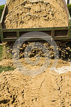 Truck dumps its load of sand