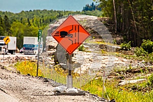 Truck entrance, left side of road ahead