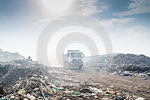 Truck at the garbage dump full of smoke, litter, plastic bottles,rubbish and trash at the Thilafushi local tropical island