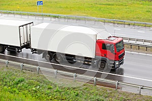 Truck goes on wet highway to rain