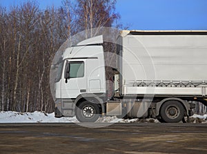 Truck goes on winter snow highway