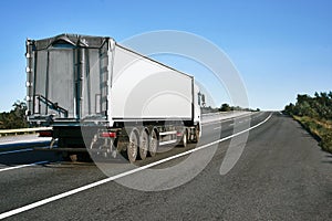 The truck is going up the road. Cargo transportation concept