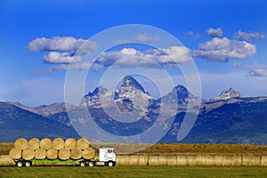 Truck Hauling Hay with Teton Mountains in Background