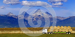 Truck Hauling Hay with Teton Mountains in Background Farming Operation