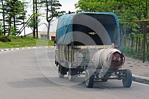 Truck hauls propane barrel on a trailer