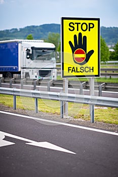 Truck on the highway in the austrian countryside with the STOP/ FALSCH stop / false sign to warn the drivers