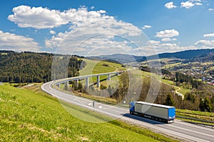 Truck on the highway through the mountainous country