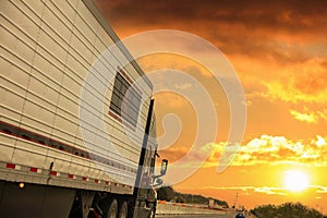 Truck on the highway, side view. cargo transportation concept. Cloudy sky at sunrise