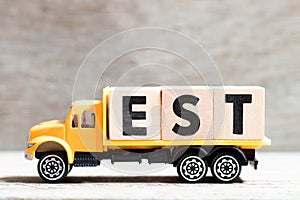 Truck hold block in word est abbreviation of established, estimated, eastern time zone, expressed sequence tag on wood