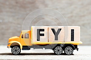 Truck hold block in word FYI Abbreviation of For your information on wood background