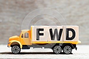 Truck hold block in word FWD Abbreviation of forward on wood background photo