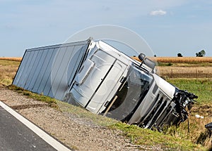 The truck lies in a side ditch after the road accident.