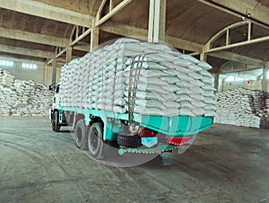 Truck loaded with bags white sacks in a warehouse godown factory stocks supply  camion charge de sacs image photo