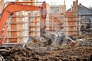 truck loader excavator moving earth and leveling a ground hole