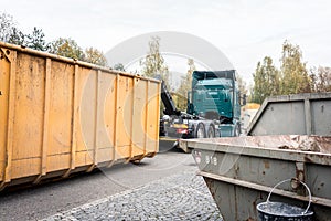 Truck loading container with waste on recycling center