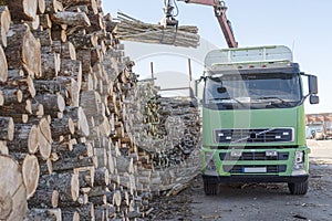 Truck loading firewood into wood warehouse