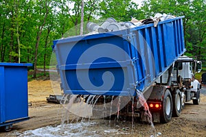 Truck loading a full recycling used construction material in the new building work site
