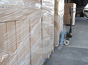 Truck loading and shipping. Stack of carton boxes on pallet ready for transport.