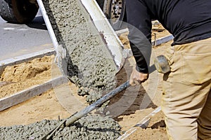 Truck mixer pouring concrete cement for construction sidewalk photo