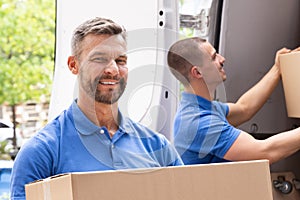 Truck Movers Loading Van Carrying Boxes