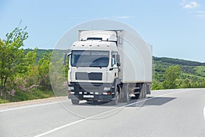 Truck moves along a suburban highway