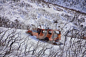 Truck old and rusty graffiti abandoned in the snow covered Mountains Lone Peak Wilderness Wasatch Rocky Mountains, Utah.