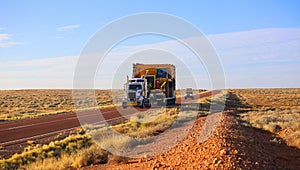 Truck oversize rides on road. Large truck driven mining dumper.