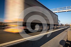 Truck passing through a toll gate on a highway, highway charges, motion blurred image