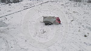 truck pours the earth in winter. 4k aerial