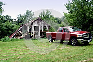 Truck pulling down old barn