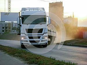 A truck pulls out onto the road. On the left is a house under construction and a blank banner with hearts.