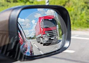 truck reflection in a car mirror