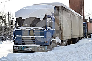 Truck. Refractor. Littered with snow. Snow drifts, unpeeled roads. Impassable snow drifts