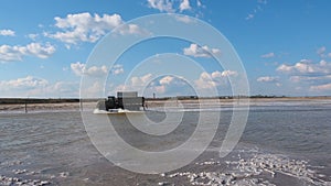 Truck rides across the lake. Truck Crossing the River. Old Soviet car runs on water. Saline salt lake Baskunchak