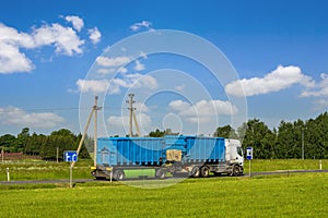 Truck on the road with blue containers