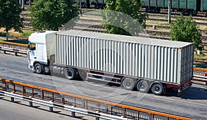 Truck on road, industrial infrastructure and railroad, cargo transportation, delivery and shipping concept