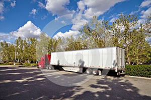 Truck on road with white blank container, blue sky, cargo transportation concept