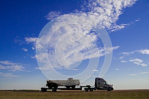 Truck is running on the freeway of the country side in America. America is a continent where American mainly live. In September Un